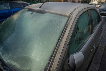 Obraz premium Colombes, France - 01 14 2025: Detail of a stationary black car covered in frost in winter.