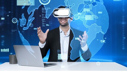 Smart project manager sharing marketing idea while sitting at table with laptop while wearing virtual reality glasses. Skilled businessman looking and checking at financial chart floating. Apparatus.