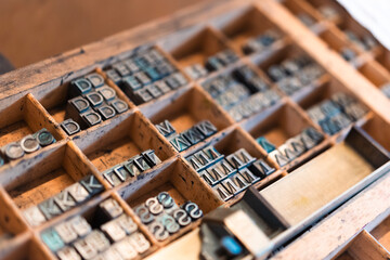 Closeup of metal printing letters in wooden compartments