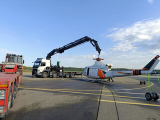 knuckle boom crane truck lifting a helicopter © Ville3