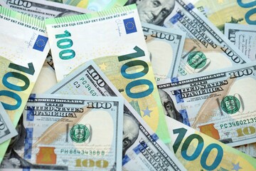 Obraz premium Big pile of Euro and USD banknotes. Many european and united states dollars