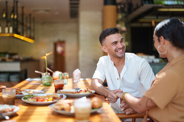 Cheerful Couple Enjoying Breakfast with Friends
