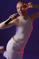 Beautiful talented singer performing on purple background