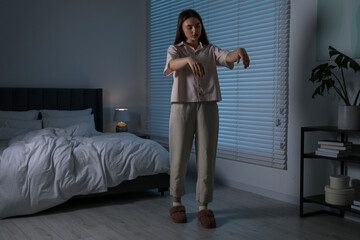 Young woman suffering from sleepwalking at home