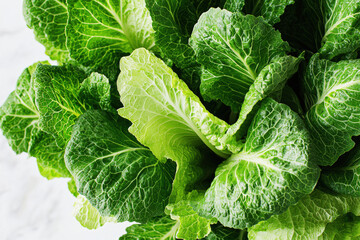 Obraz premium Fresh romaine lettuce with crisp green leaves showcasing vivid textures against a clean white background