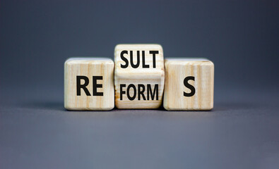 Reform and result symbol. Concept words Reforms Results on beautiful wooden block. Beautiful grey...
