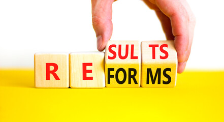 Reform and result symbol. Concept words Reforms Results on beautiful wooden block. Beautiful yellow...