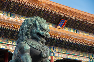 Powerful bronze lion statue guarding the Forbidden City, showcasing intricate imperial...