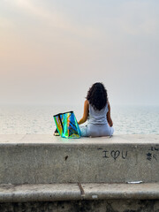 Mumbai, Maharashtra, India - 04 Dec 2024: A women doing yoga on Marine Drive