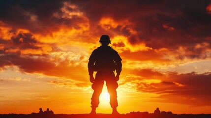 A soldier's silhouette stands against a vibrant orange and red sunset sky with clouds