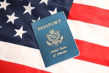 Fototapeta premium Latest version of United States of America citizen Passport on USA national flag