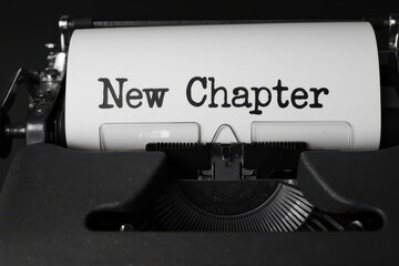 a typewriter with the word new chapter written on it
