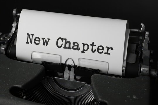 new chapter - a typewriter with a paper with the word new chapter