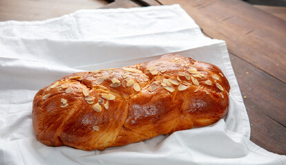 Easter sweet bread, homemade tsoureki braid on white table cloth