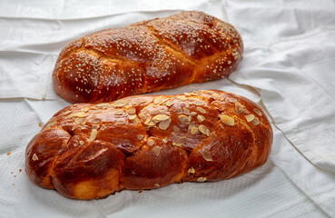 Easter sweet bread, two tsoureki braids on white table cloth