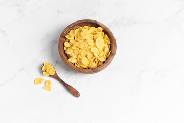 cornflakes  in a bowl on a light background, breakfast