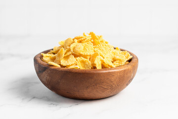 cornflakes  in a bowl on a light background, breakfast