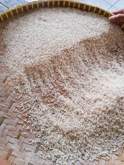 Take a close-up look at the traditional way of sifting rice with a rattan basket, or tampah, in Indonesia.