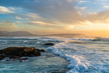 Beautiful ocean waves at a beach in Cape Town South Africa at sunset