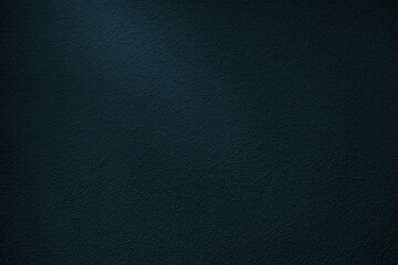 Dark wall background in a bluish tone. Dark grainy wall texture in the dark with a ray of light