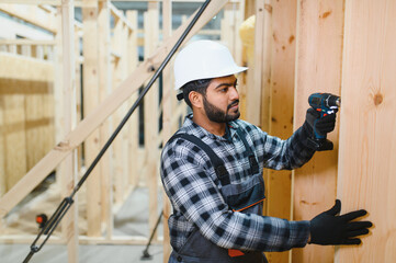 Construction of modular houses. Indian construction worker or engineer at construction site