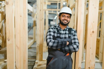 Indian carpenter works on the construction of modular houses