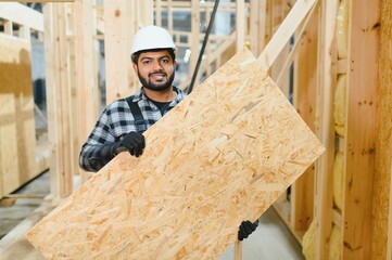 Indian carpenter works on the construction of modular houses