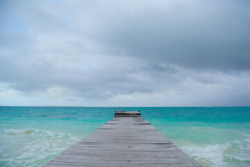 Fototapeta premium Seagull on a pier overlooking the Caribbean Sea.
