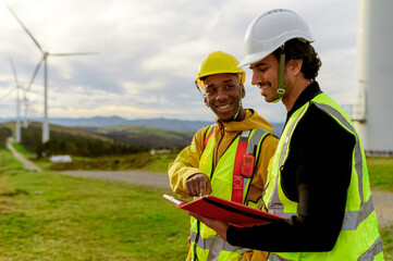 Engineer and operator consulting documents about a wind turbine park project