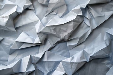 Fototapeta premium Crumpled paper creating a textured backdrop with areas of light and shadow