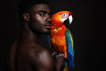 An engaging portrait of a man holding a red macaw, illustrating a vibrant connection with wildlife and showcasing rich colors against a dark background.