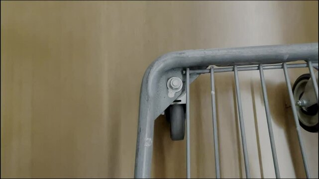 A wobbly shopping cart wheel at the grocery store