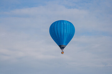 Blue hot air balloon isolated in a summer sky