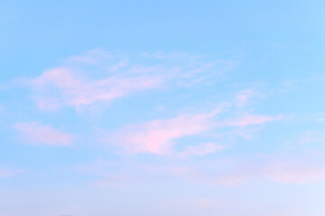 Bright blue sky with light pink clouds