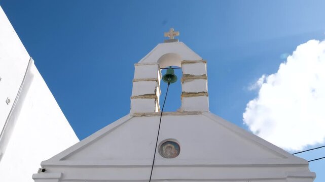 View of Mykonos town with famous windmills, and port with boats and cruise ship on summer day. Mykonos, Cyclades islands, Greece. With camera pan