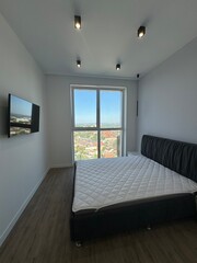 Modern minimalist bedroom with panoramic city view