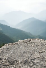 Misty mountain range with rocky foreground. Serene landscape for travel, adventure, and nature-themed designs. Perfect for Earth Day, hiking promotions, and environmental awareness 
