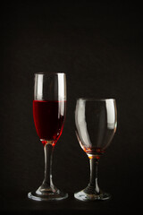 Portrait of a pair of red wine glasses on a black silhouette background, red wine champagne