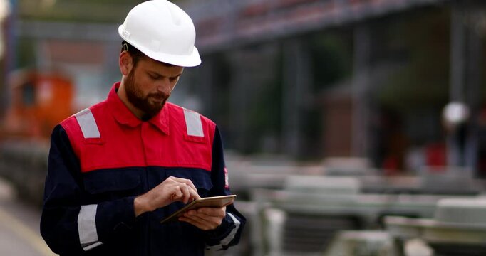 An engineer in a train maintenance area, wearing safety gear and making a phone call. This image highlights professionalism, communication,perfect for railway and industrial projects.
