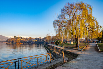 Ioannina lake in Greece with reflective waters and birds in sunset. 