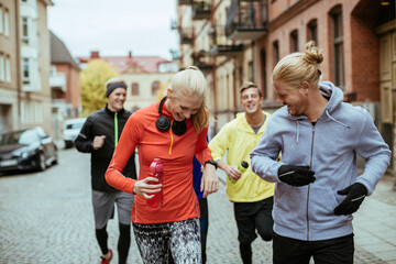 Group of friends jogging together in the city