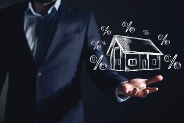 businessman holding house with drawn percentage icons