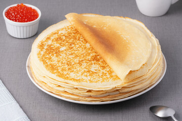 Freshly baked pancakes with red caviar