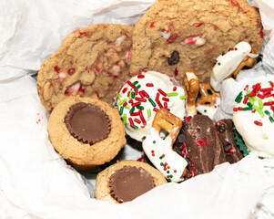 Closeup of assorted holiday treats in white tissue paper
