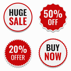 Red and white sale stickers on a light background. Red and white labels.