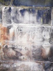 Obraz premium Background: Uneven old wall with different colored patched clinker bricks. Closeup. Walls of Edinburgh, Scotland, UK. Sandstone. Moss stains. Antique