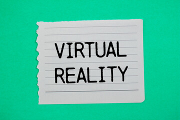 Virtual reality message written on ripped torn paper piece with green background. Conceptual virtual reality symbol. Copy space.