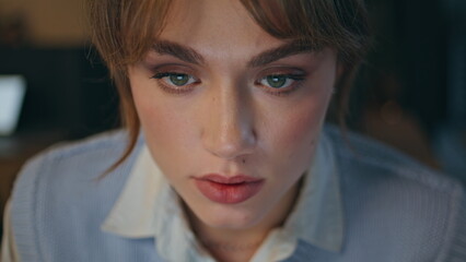 Late worker staring computer at dark interior closeup. Overworked businesswoman