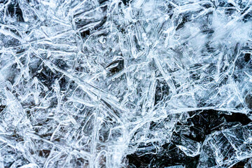 Close-up of the surface of a frozen stream, in a coniferous forest in winter, Norway, macro