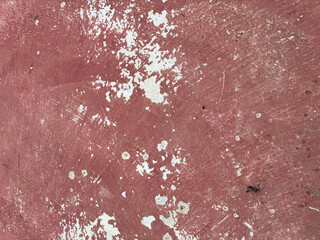 Textured surface with visible wear and paint splatter in muted colors